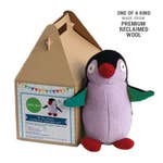 A brown takeout-style box sits next to a stuffed penguin made from brightly colored reclaimed wool. 