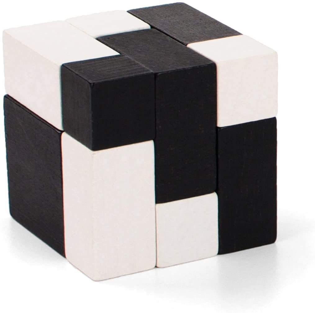 A cube is formed from black and white wooden pieces of varying shapes and sizes