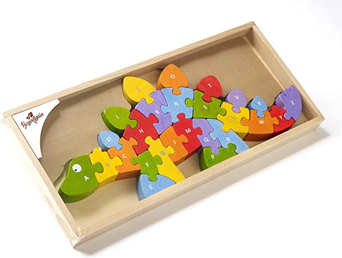 A rainbow colored wooden dinosaur puzzle is put together in the box; the pieces are labeled A-Z from nose to tail