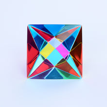 A light prism cube shows many different colors reflected