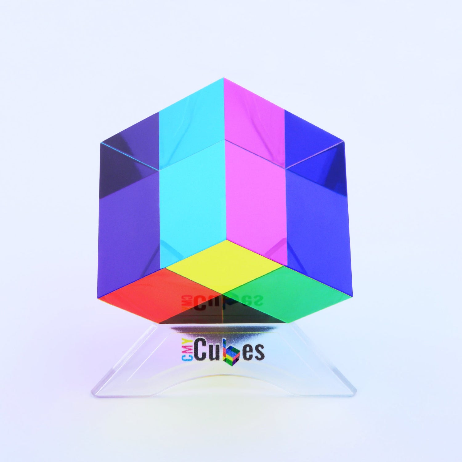 A brightly colored rubix cube-type fidget toy in bright primary colors sits on a stand