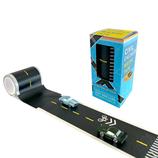 Tape that looks like a road with toy cars on it sits in front of a blue box containing a roll of the tape
