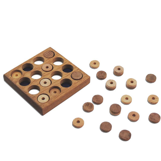 A larger wooden square with round holes. Wooden pegs are scattered around the box.